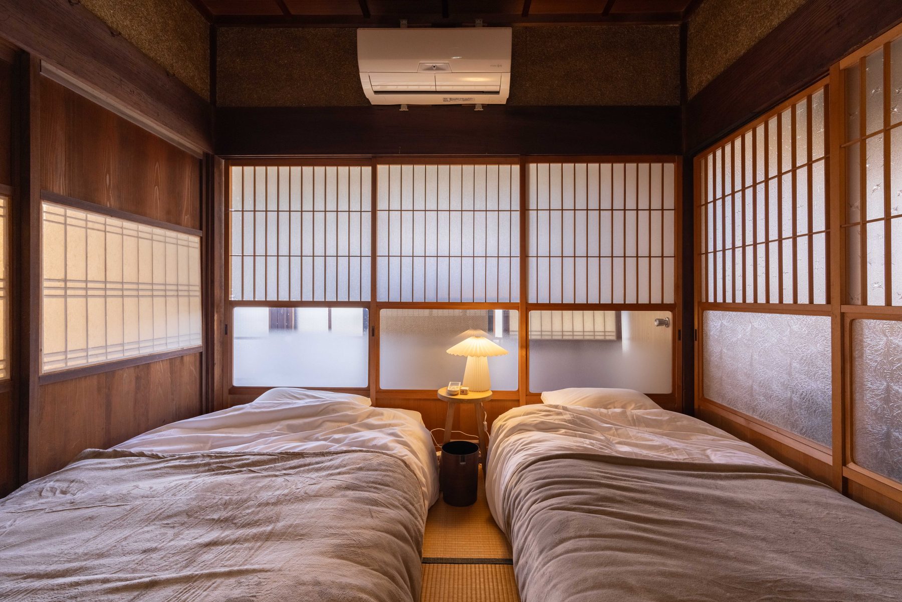 Low mattress beds placed directly on the tatami — a Japanese-style bedroom where families can sleep side by side.